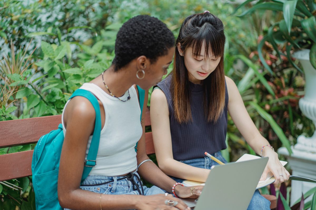 Two students studying together in a park