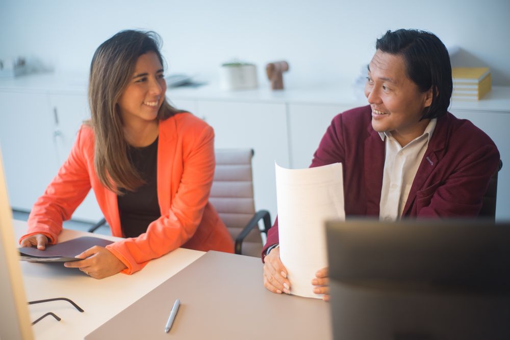 A mentor and mentee discussing a document