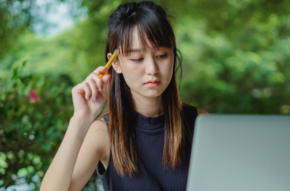 A student looking up scholarship information on a laptop